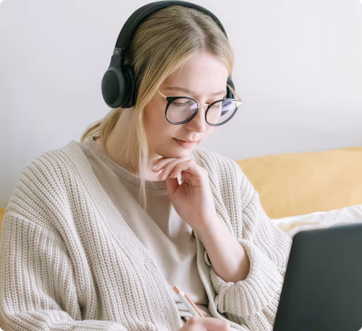 Annual maintenance bundle — professional working on a laptop with headphones.
